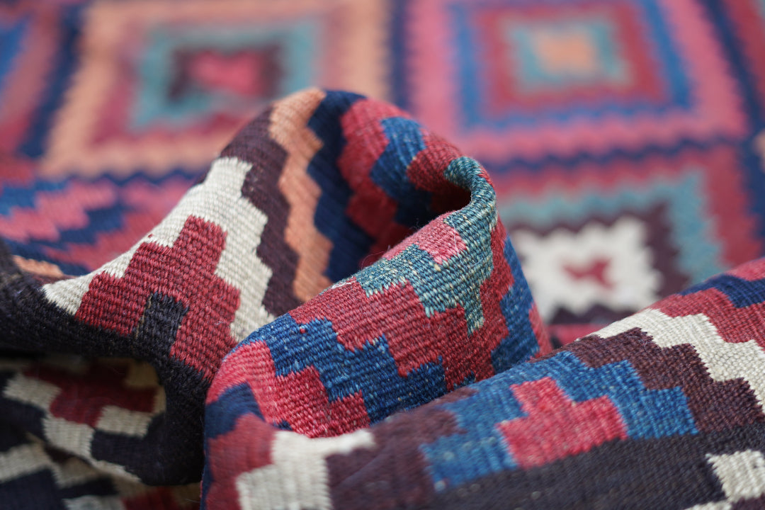 Detailed close-up of a handwoven antique Persian rug with bold geometric patterns, featured in the final section before the email signup on Oba Gallery.